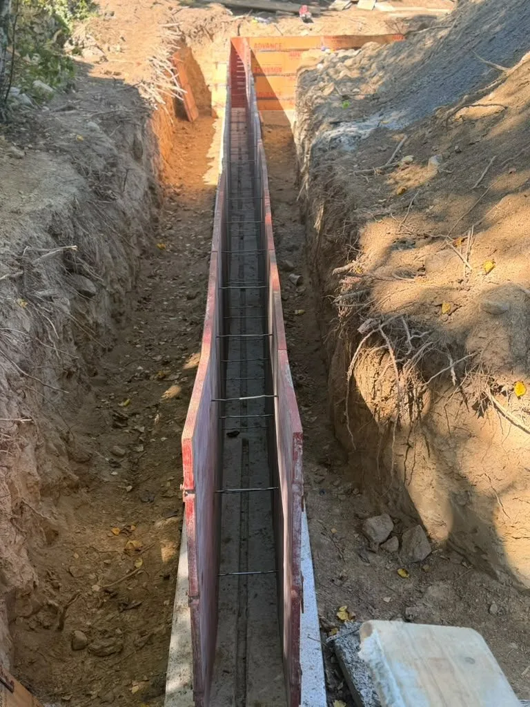 Footing forms with rebar in a trench