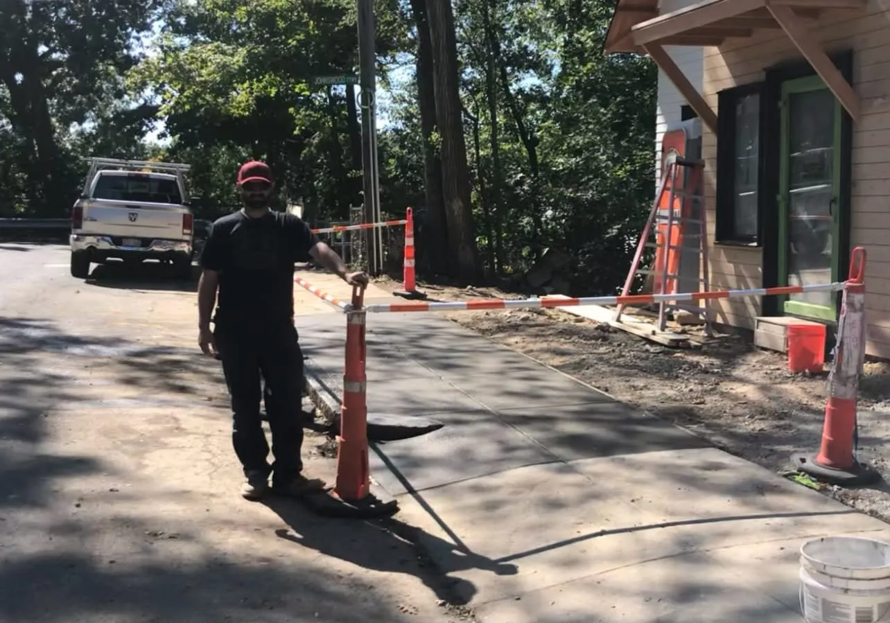 Fresh concrete flatwork beside a house