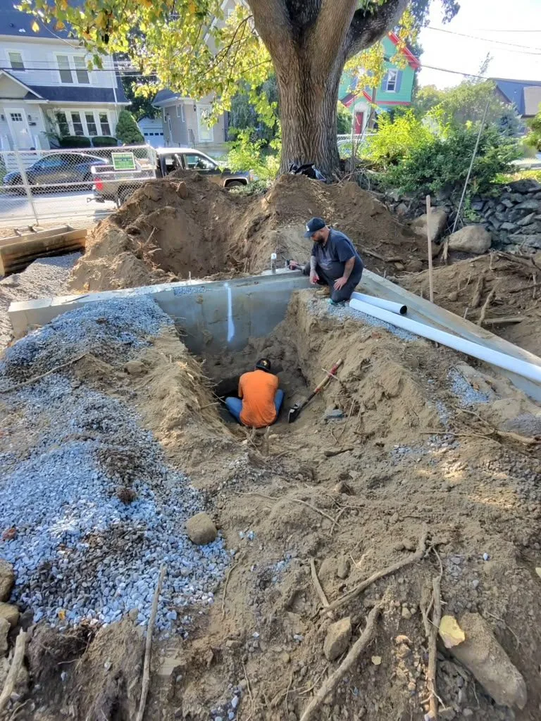 Excavation at a new foundation with pipes set in gravel