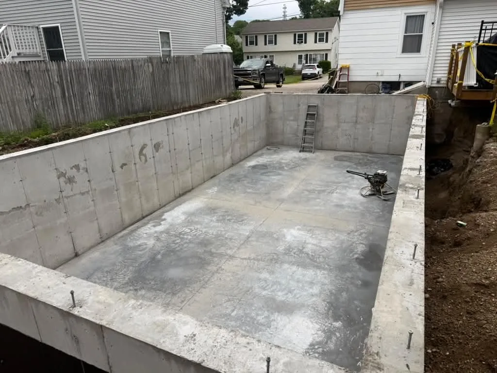 A finished basement slab inside poured foundation walls
